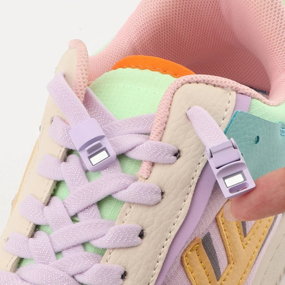 Close-up of pink elastic no-tie shoelaces with magnetic lock on a sneaker, showing how the laces snap securely for an easy slip-on fit.